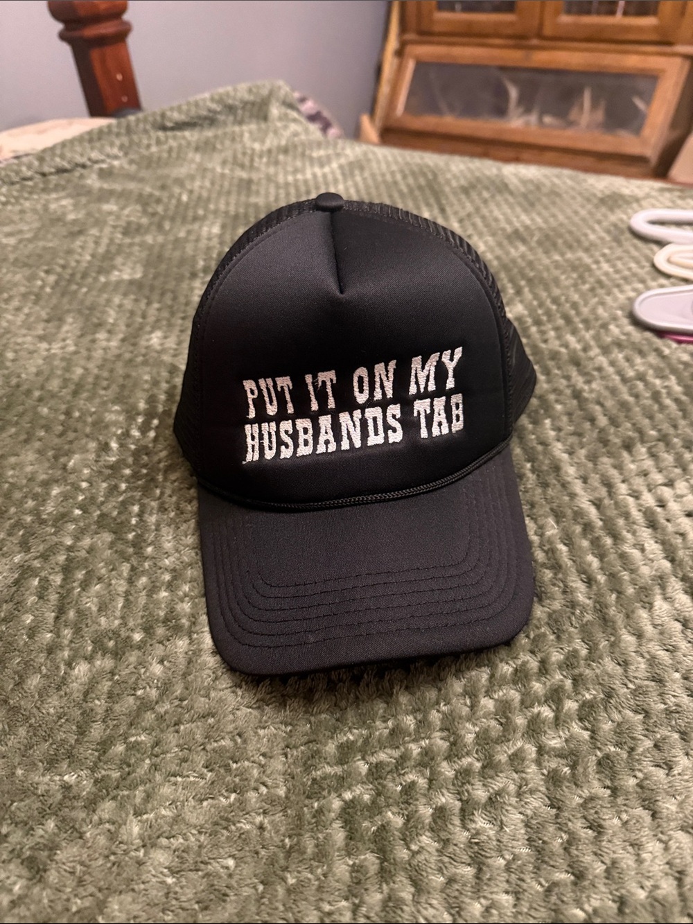 Black Trucker Cap with 'Put It On My Husbands Tab' Embroidery